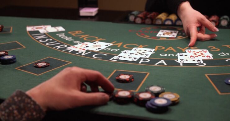 Person sitting at a table playing blackjack with live dealer